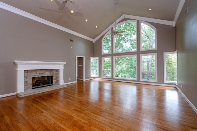 unfurnished living room featuring ceiling fan, a healthy amount of sunlight, and wood-type flooring