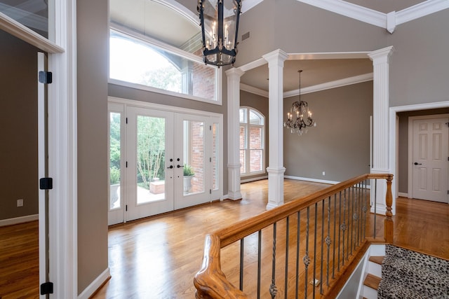 foyer entrance featuring plenty of natural light, a notable chandelier, and wood-type flooring