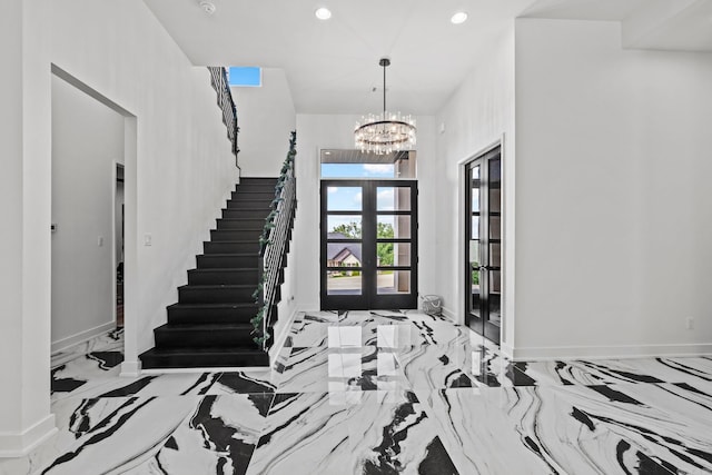 foyer featuring a chandelier and french doors