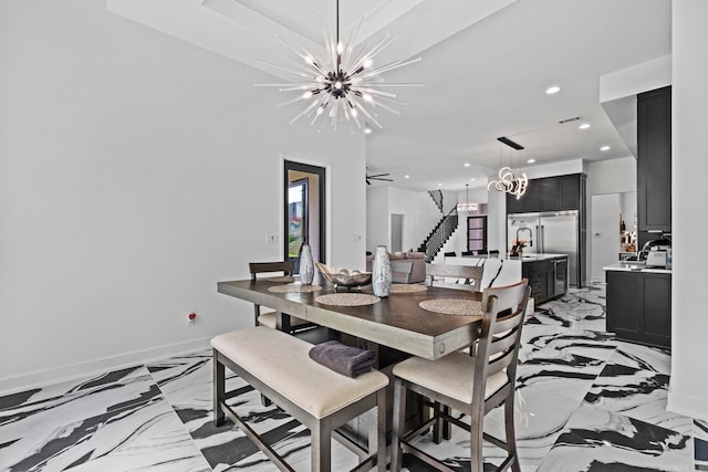 dining space with ceiling fan with notable chandelier