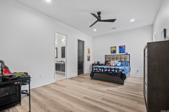 bedroom featuring light hardwood / wood-style flooring, ensuite bath, and ceiling fan