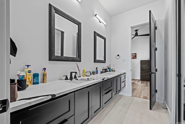 bathroom with hardwood / wood-style floors, vanity, and ceiling fan