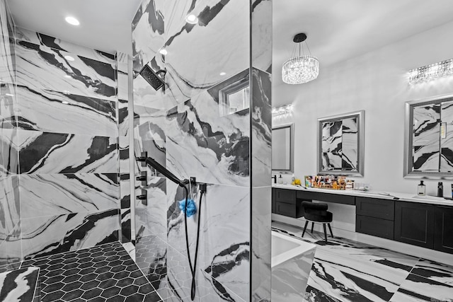 bathroom featuring tiled shower and vanity