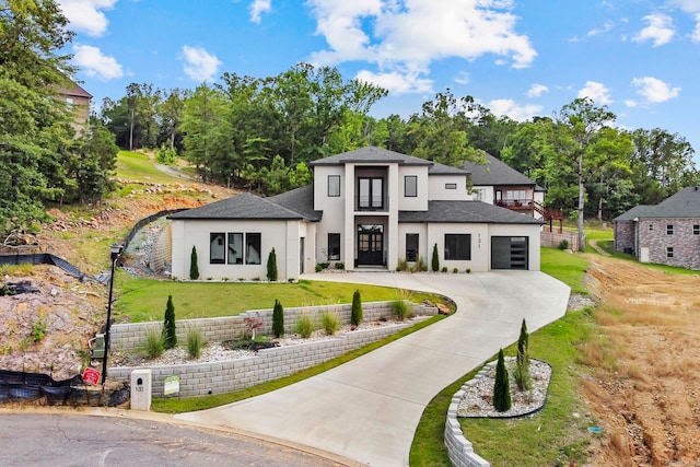 view of front of home with a front lawn and a garage