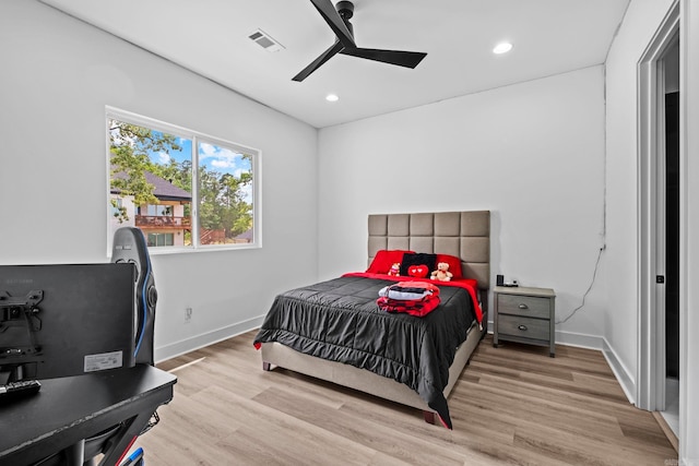 bedroom with ceiling fan and light hardwood / wood-style floors