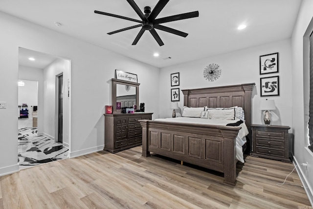 bedroom with ceiling fan and light hardwood / wood-style floors