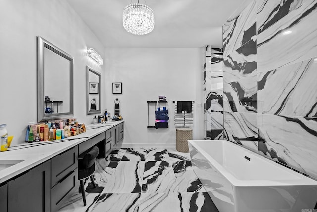 bathroom featuring a washtub, vanity, and a chandelier