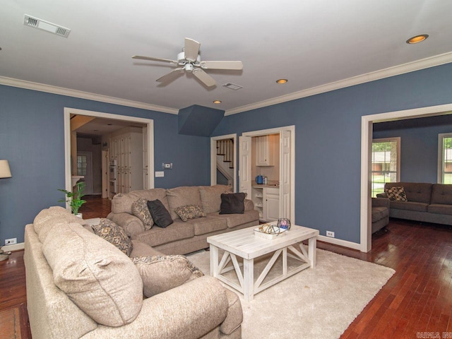 living room with dark hardwood / wood-style floors, ceiling fan, and ornamental molding