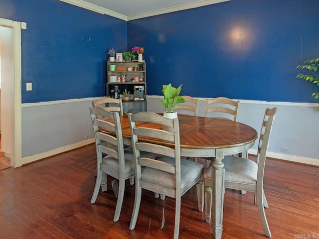 dining area with hardwood / wood-style flooring and ornamental molding