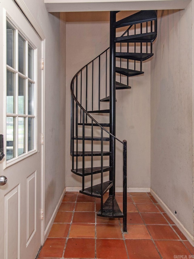 stairway with tile patterned floors