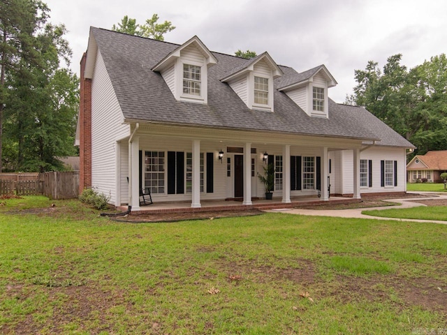 cape cod house featuring a patio and a front yard