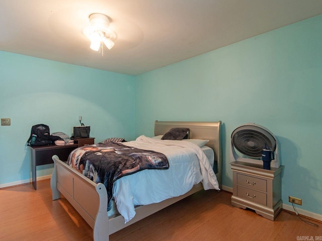 bedroom featuring light wood-type flooring and ceiling fan