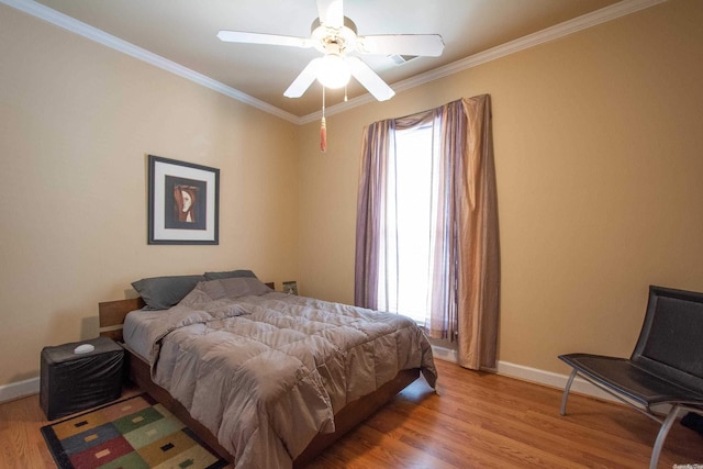 bedroom with light hardwood / wood-style flooring, ceiling fan, and ornamental molding