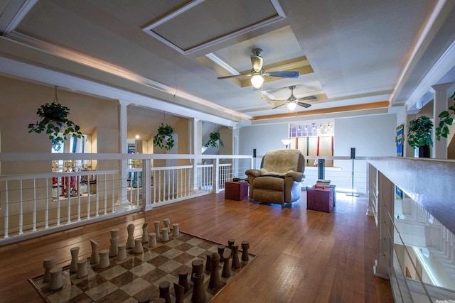 sitting room with hardwood / wood-style floors, a tray ceiling, ceiling fan, and ornamental molding