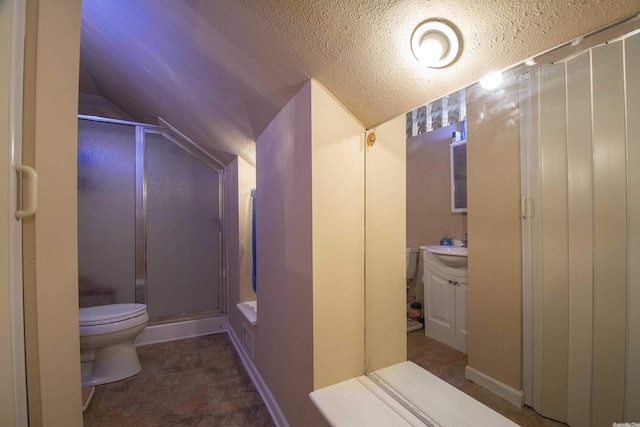 bathroom featuring a textured ceiling, an enclosed shower, vaulted ceiling, toilet, and vanity