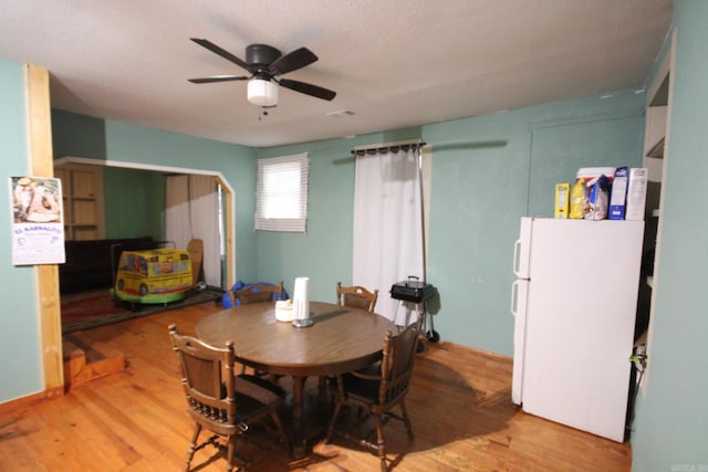 dining area featuring ceiling fan and light wood finished floors