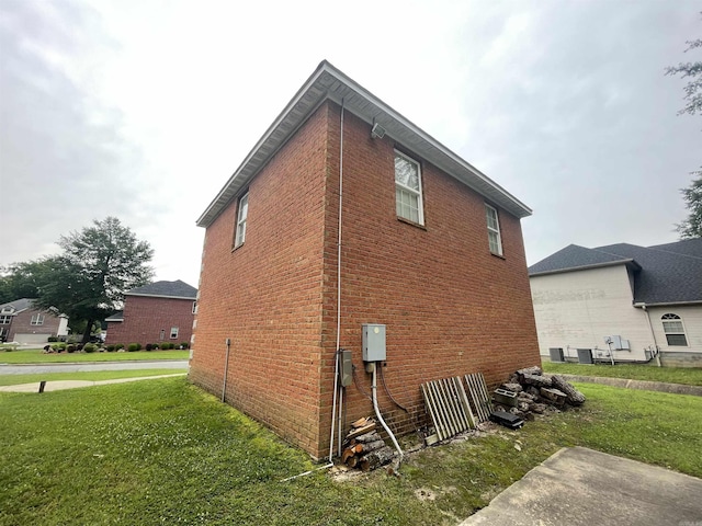 view of home's exterior with a lawn