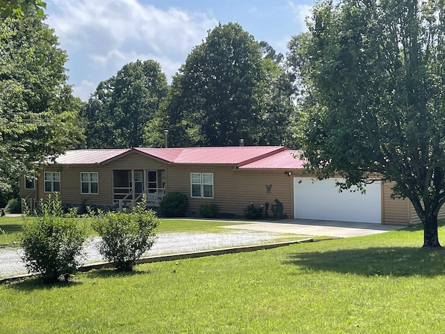 view of front of home featuring driveway, metal roof, an attached garage, and a front lawn