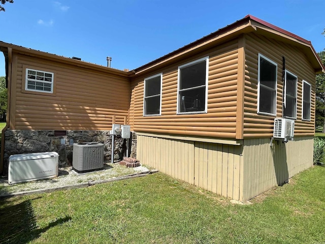 view of side of property with central AC and a lawn