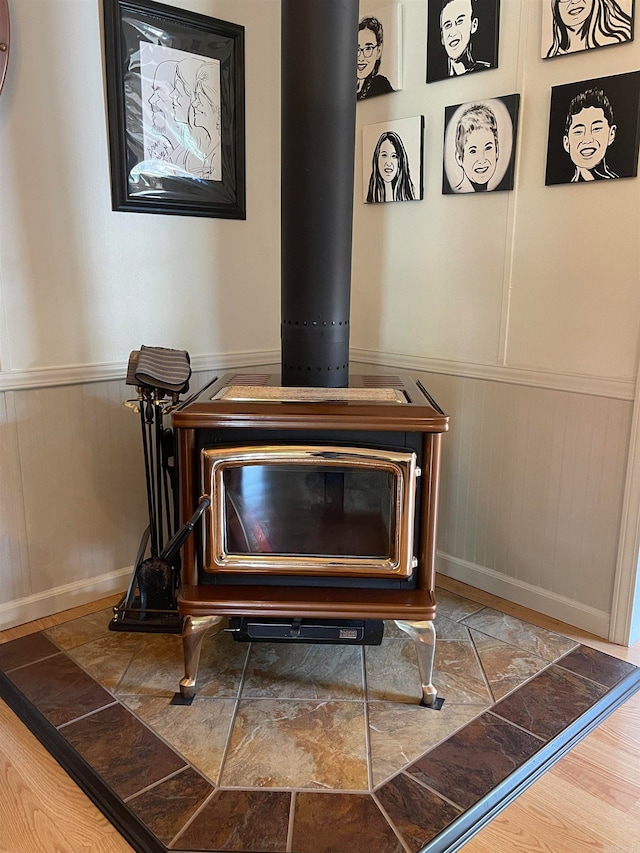 room details with hardwood / wood-style flooring and a wood stove