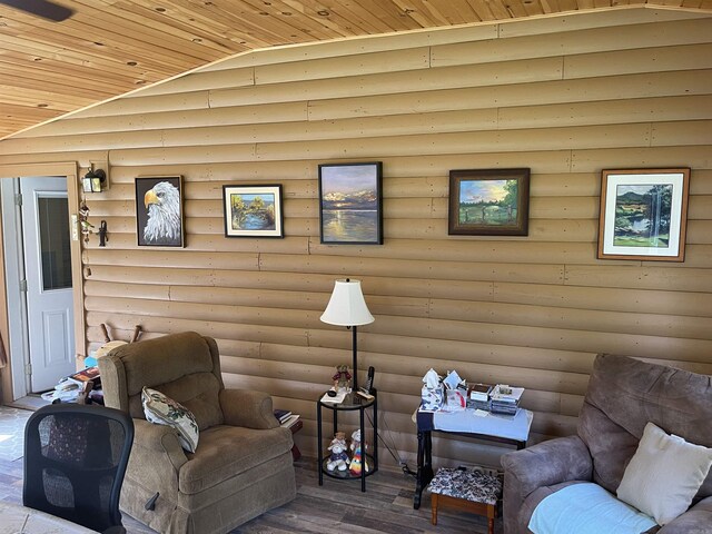 living room featuring hardwood / wood-style floors, lofted ceiling, wood ceiling, and log walls