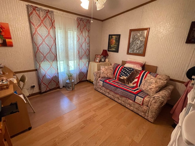 living room with ceiling fan, ornamental molding, and hardwood / wood-style floors