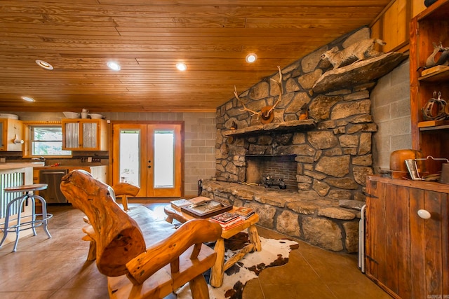 tiled living room featuring a fireplace, french doors, wooden ceiling, and sink