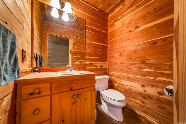 bathroom featuring vanity, toilet, wooden ceiling, and wooden walls