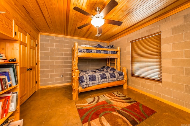 tiled bedroom featuring ceiling fan and wood ceiling