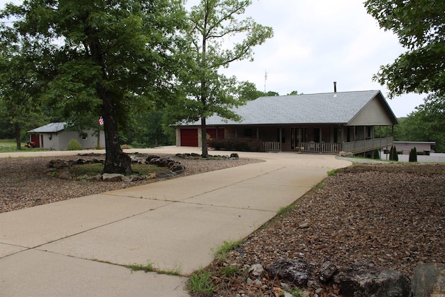 view of front of house featuring covered porch and a garage