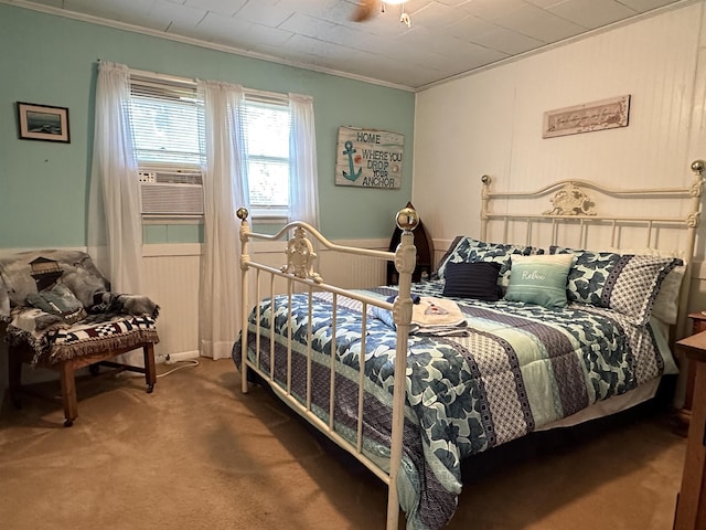 bedroom featuring ceiling fan, cooling unit, carpet floors, and ornamental molding