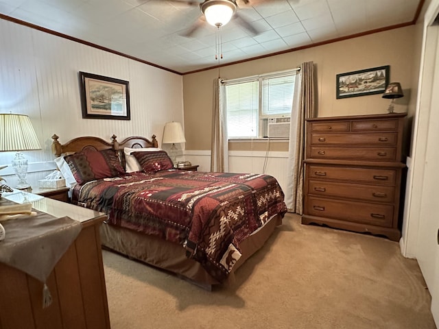 carpeted bedroom featuring ceiling fan and ornamental molding