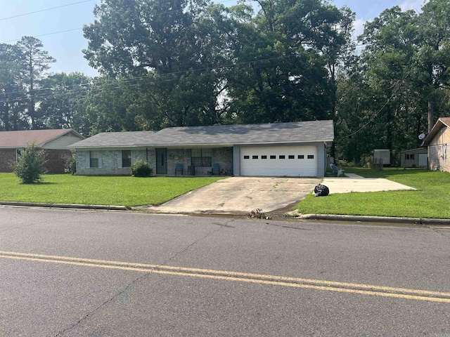 ranch-style house featuring a garage and a front lawn