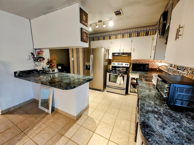kitchen featuring sink, white cabinetry, stainless steel appliances, and light tile patterned floors