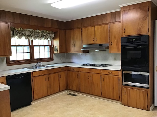 kitchen with black appliances, sink, and tasteful backsplash