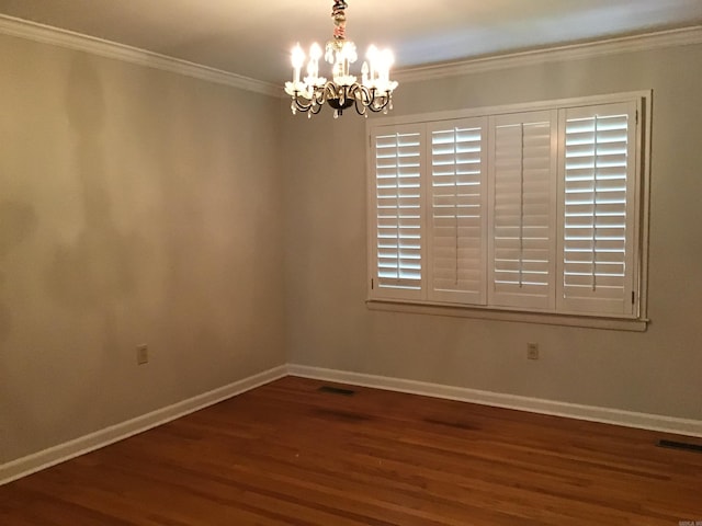 unfurnished room featuring ornamental molding, dark wood-type flooring, and a notable chandelier