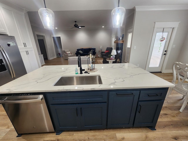 kitchen featuring white cabinetry, dishwasher, hanging light fixtures, and sink