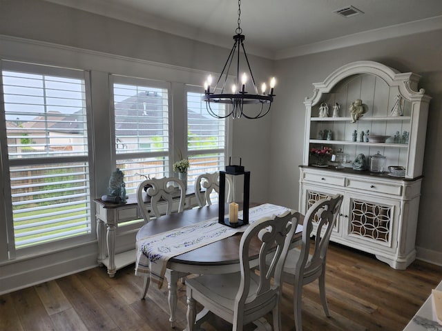 dining area featuring a healthy amount of sunlight, dark hardwood / wood-style flooring, and a notable chandelier