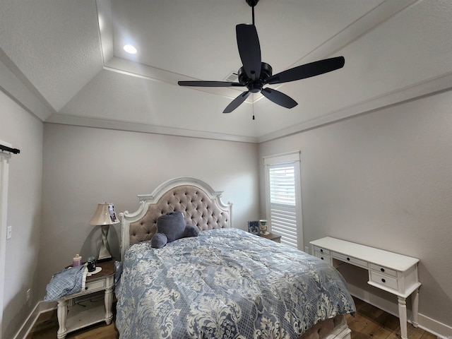 bedroom featuring dark hardwood / wood-style floors, vaulted ceiling, ceiling fan, and crown molding