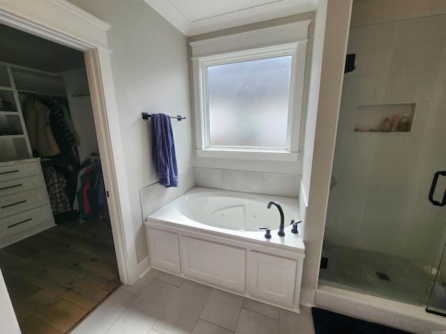 bathroom featuring tile patterned flooring, separate shower and tub, and ornamental molding