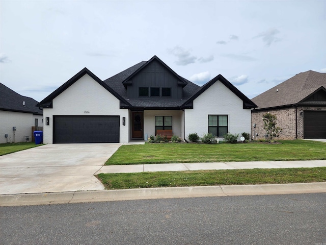 view of front facade with a garage and a front lawn