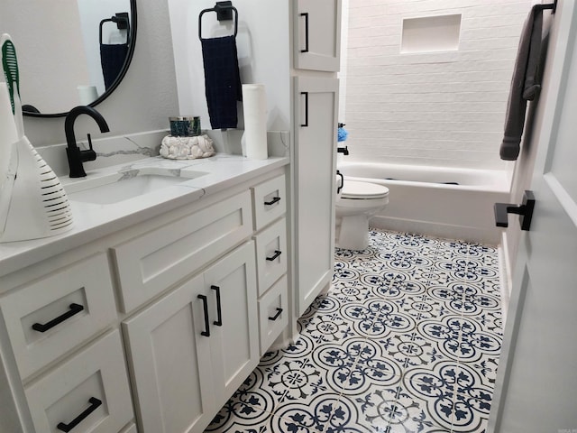 full bathroom with vanity, tiled shower / bath, and toilet