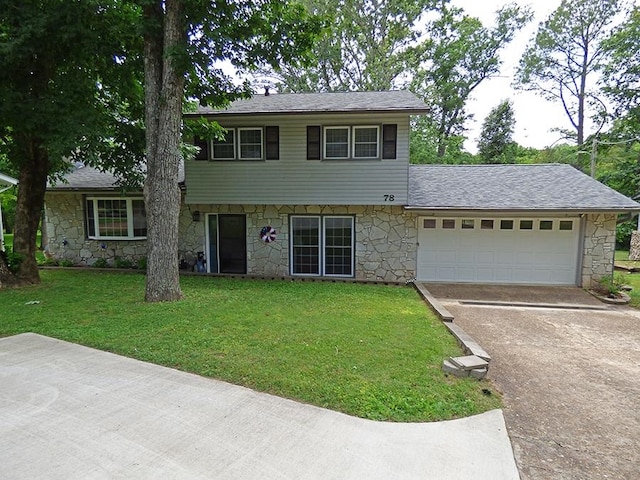 view of front of house with a front yard and a garage