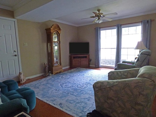 living room featuring hardwood / wood-style flooring, ornamental molding, and ceiling fan