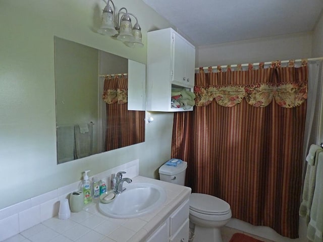 bathroom featuring tile flooring, toilet, and large vanity