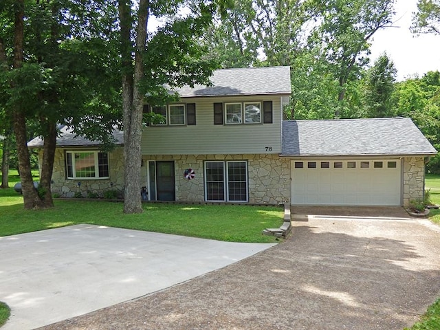 view of front of property with a front yard and a garage