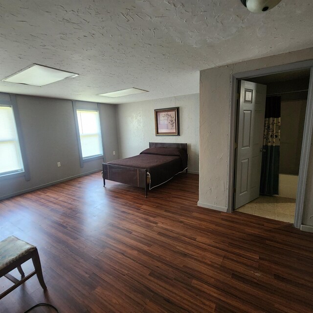 1947 63rd Hwy, Hardy, AR 72542 - unfurnished bedroom with baseboards, wood finished floors, a textured wall, and a textured ceiling