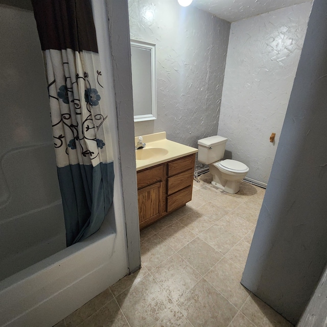 full bathroom with vanity, toilet, tile floors, and shower / bath combo