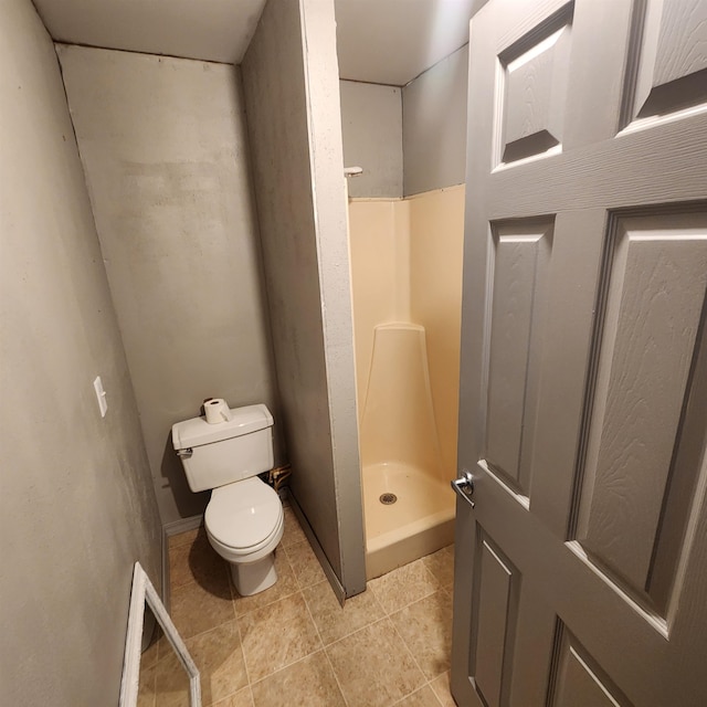 bathroom featuring walk in shower, tile flooring, and toilet