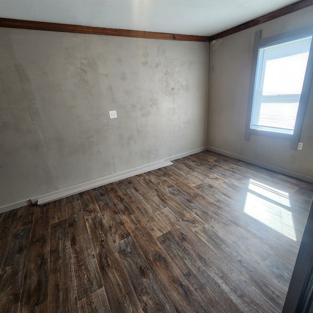 unfurnished room featuring dark hardwood / wood-style floors and crown molding